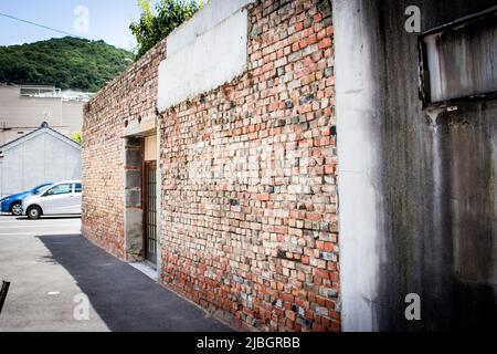Old brick house on the street from angled view, Japan Stock Photo