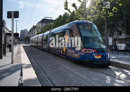 Electric tram train of the Strasbourg public transport company (CTS) running on a street Stock Photo