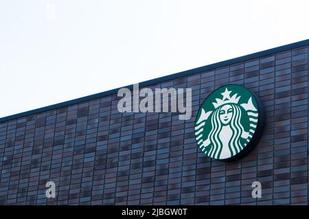 Starbucks Coffee logo on the store wall. The first Starbucks location outside North America opened in Tokyo, Japan, in 1996 Stock Photo