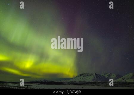 Aurora Borealis over Tahneta Pass in Southcentral Alaska. Stock Photo