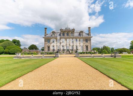 Kingston Lacy Country House with short grass and gravel path on a sunny day with white clouds.  Wimborne, Dorset, England. Stock Photo