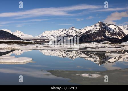 Mountain reflections and icebergs in Sheridan Lake at terminus of Sheridan Glacier in Southcentral Alaska. Stock Photo