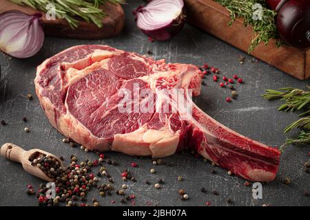 Side view on raw beef american tomahawk steak Stock Photo