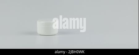 Skincare and cosmetology banner mockup. Unbranded white plastic jar for cosmetics products. Branding identity template for text and design Stock Photo
