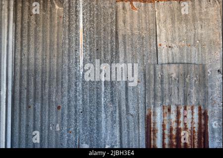 Old rusted decay galvanized fence or roof background Stock Photo