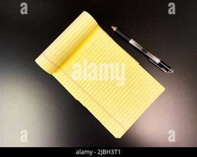 A yellow legal pad notepad Stock Photo