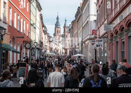 Many people walking along the main street in the old town from the German city Heidelberg. Stock Photo