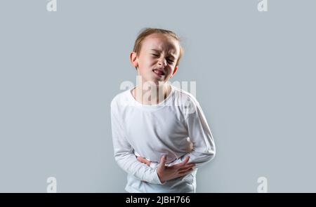 Stomach pain. Teen boy with stomachache. Child having terrible pain in stomach. Diarrhea or gastroenteritis health problem. Child has stomachache with Stock Photo
