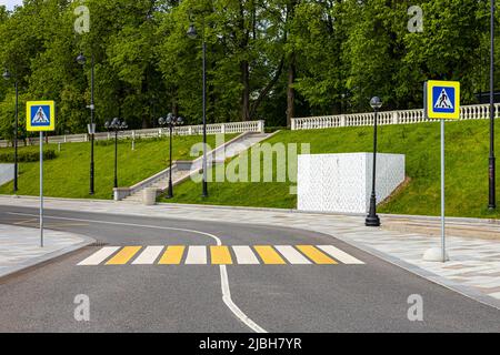 pedestrian crossing across the road with zebra crossing and signs Stock Photo