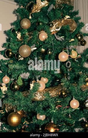 Christmas tree adorned with golden globes and angels Stock Photo