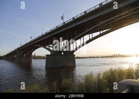 Evening view on the October bridge / Communal bridge across the river Ob in Novosibirsk, Siberia, Russia Stock Photo