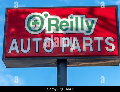 O'Reilly Auto Parts store's outdoor, free standing brand and logo street advertising in sunset light with shadows in Salisbury, North Carolina. Stock Photo
