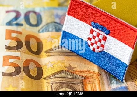 The flag of Croatia against the background of the single currency of the European Union, The concept of Croatia joining the Euro zone Stock Photo