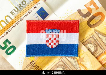 The flag of Croatia against the background of the single currency of the European Union, The concept of Croatia joining the Euro zone Stock Photo