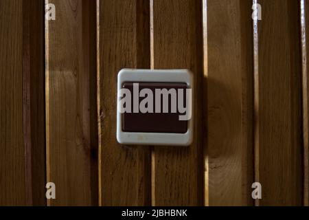 old vintage switch on a wall from woodden panels Stock Photo