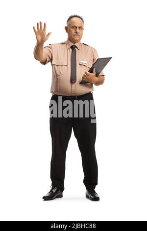 Full length portrait of a serious security officer gesturing stop with hand isolated on white background Stock Photo