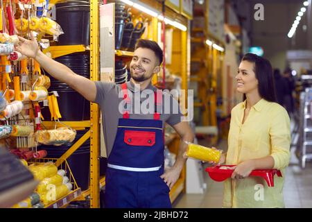 Happy female shopper in building materials store chooses tools for home make repairs. Stock Photo