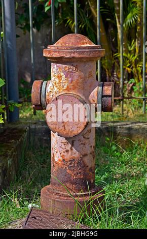 Old fire hydrant next to the sidewalk of a residential condominium, Rio Stock Photo