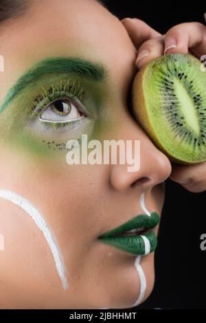 Kiwi woman fantasy makeup portrait Stock Photo