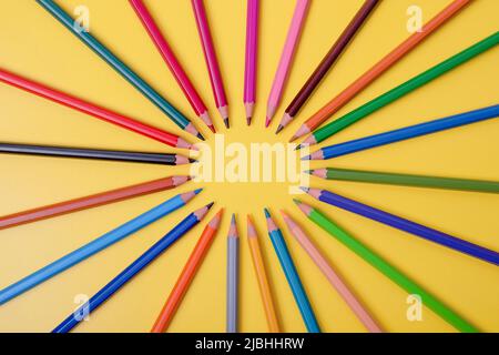 a few colored pencils on a yellow-blue background Develop creativity Get creative Stock Photo