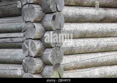 Old grey barn or farmhouse. With some shadows and beautiful aged timber. Horizontal photo. A log wall of wooden house. Stock Photo