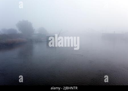 Comacchio, Italy - December 29, 2019: view of fishing house in the fog Stock Photo