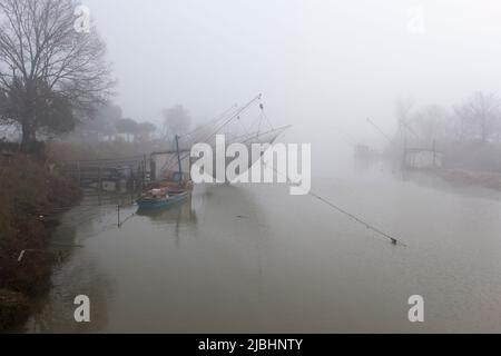 Comacchio, Italy - December 29, 2019: view of fishing house in the fog Stock Photo