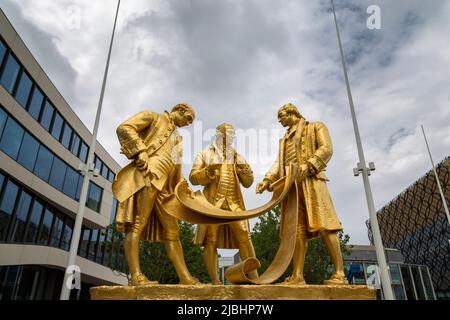 Matthew Boulton, James Watt and William Murdoch are depicted in Boulton, Watt and Murdoch, a gilded bronze statue in Centenary Square, Birmingham, UK. Stock Photo