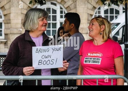 Westminster, London, UK. 06th June, 2022. Two anti-government protesters chat in Westminster. The area outside Parliament is today busy with journalists, photographers and camera teams keen to interview politicians and commentators. The vote of confidence in PM Boris Johnson is scheduled to take place 6-8pm today. Credit: Imageplotter/Alamy Live News Stock Photo