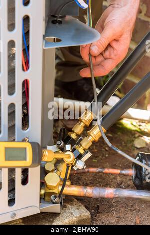 Technician in connecting outdoor new air conditioning unit Stock Photo
