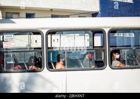 Passengers wearing a protective mask against covid-19 inside the bus in the city of Salvador, Bahia. Stock Photo