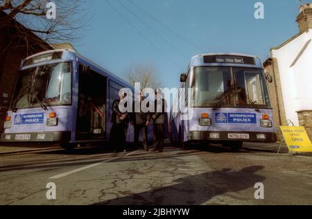 Mobile London Met Police bus with police officers standing to attention Stock Photo