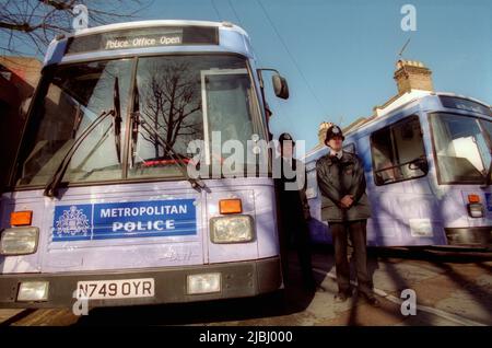 Mobile London Met Police bus with police officers standing to attention Stock Photo