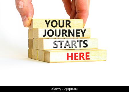 Your journey starts here symbol. Concept words Your journey starts here on wooden blocks on a beautiful white table white background. Business, motiva Stock Photo