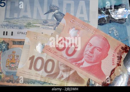 Toronto, Canada - October 30. 2021: Canadian Dollar Banknotes piled up, new and old CAD bills Stock Photo