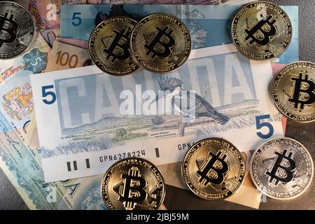 Toronto, Canada - October 30. 2021: Bitcoin on beautiful 5 Canadian Dollar banknote. Cryptocurrency trading and mining in Canada Stock Photo