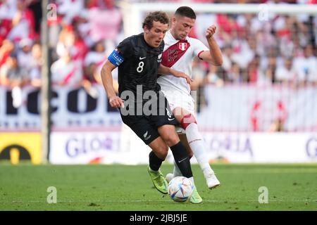 Joe Bell of New Zealand and Renato Tapia of Peru during the friendly match between Peru and New Zealand played at RCDE Stadium on June 5, 2022 in Barcelona, Spain. (Photo by Bagu Blanco / PRESSINPHOTO) Stock Photo