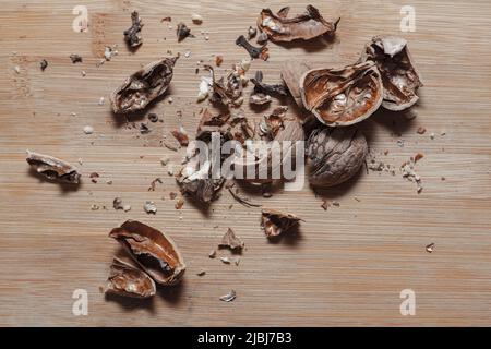 Shelled walnut . Peeled nut shell , wooden background Stock Photo