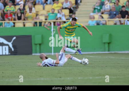 St. Petersburg, FL: Louisville City FC forward Brian Ownby (10) slide tackles and nearly trips Tampa Bay Rowdies midfielder Jake Areman (8) during a U Stock Photo