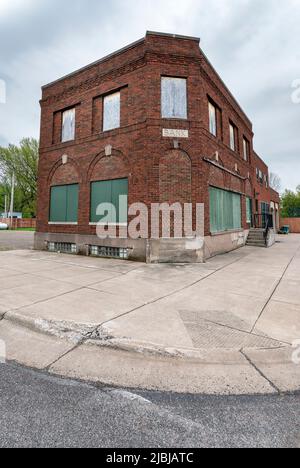 Exterior of an old abandoned brick bank building in the village of Meadowlands Stock Photo