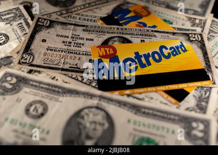 Manhattan, New York/USA - March 26. 2021: Metro card on old twenty dollar banknote. Two dollar bill out of focus next to Metrocards. Ticket for NY Sub Stock Photo