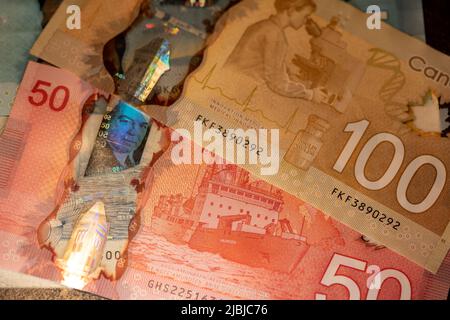Toronto, Canada - October 30. 2021: Fifty and one Hundred Canadian Dollar banknotes. New design of CAD money Stock Photo