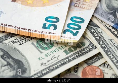 200 Euro banknote next to 50 euros on top of one hundred dollar bills. Trading Euro with Dollar. Stock Photo