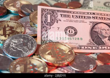 Bitcoin between dollar coins and banknotes. One Eisenhower dollar next to gold Bitcoin and one dollar banknote. Crypto currency exchange concept Stock Photo