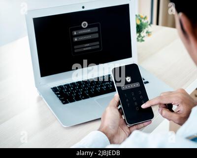 Two factor authentication or 2FA concept. Safety shield icon while access on phone with laptop for validate password, Identity verification, cybersecu Stock Photo