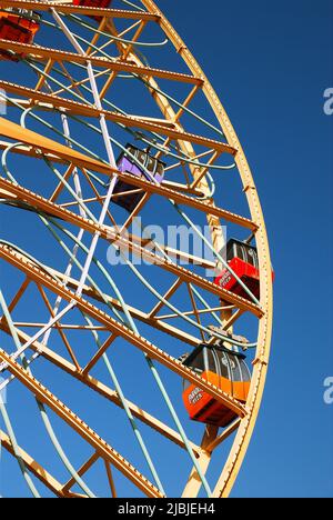 The Ferris Wheel takes riders on a relaxing trip for a nice view at an amusement park Stock Photo