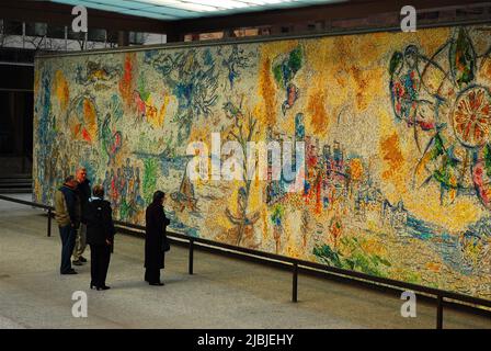 A group of friends admire Marc Chagall's mosaic entitled Four Seasons in the Loop of Chicago Stock Photo