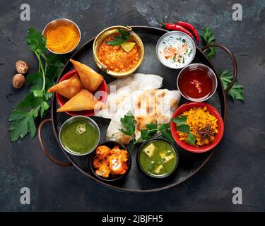 Indian Thali on dark background. Traditional food concept. Organic food concept. Dishes and appetisers of indeed cuisine. Top view, flat view Stock Photo