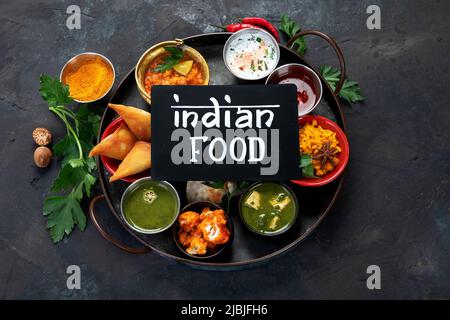 Indian Thali on dark background. Traditional food concept. Organic food concept. Dishes and appetisers of indeed cuisine. Top view, flat view Stock Photo
