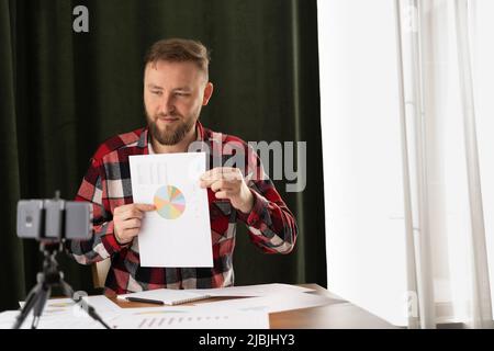 Team work online process. young business managers crew working with new startup project, analyzing graph plans, business video presentation using Stock Photo